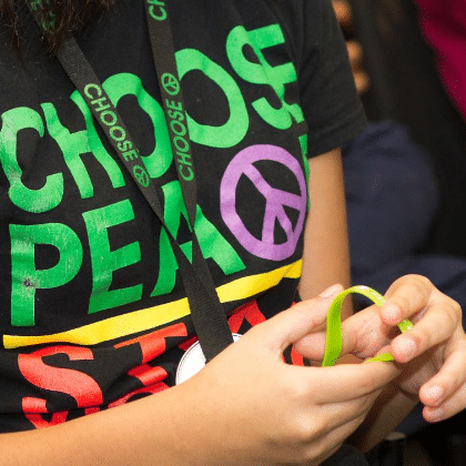 person wearing choose peace stop violence shirt