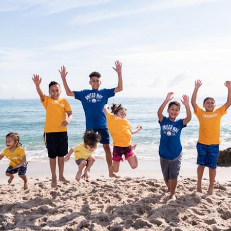 kids jumping on beach