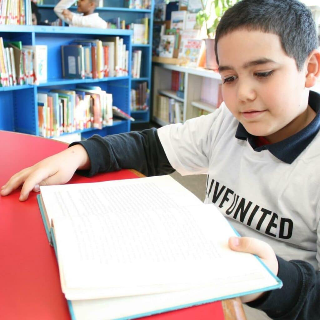 young child reading book