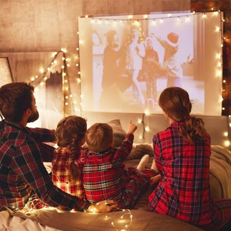 family watching movie in Christmas PJs